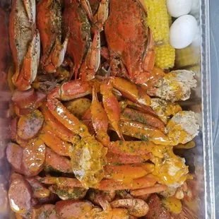 a tray of crab, corn, and eggs