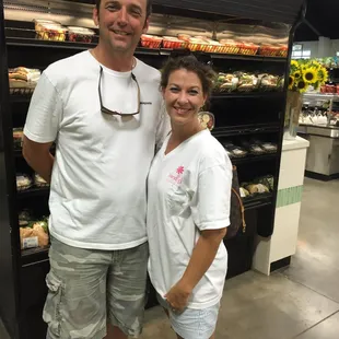 a man and a woman standing in front of a store