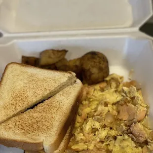  sandwich and scrambled eggs in a styrofoam container