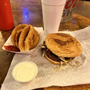 Swiss mushroom burger with bacon and grilled onions and a side of onion rings with ranch.