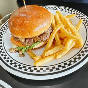 Burger with mushrooms, lettuce and tomato and garlic fries