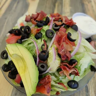 a salad with avocado and bacon