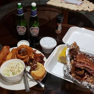 Side of slaw with a small portion of the Family Platter appetizer. On the right is the Jake&apos;s Super BBQ Sampler. Peroni goes great with this