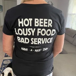 a woman wearing a hot beer lousy food bad service t - shirt