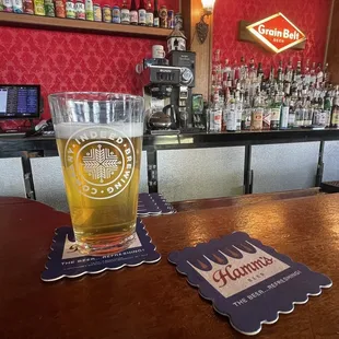 a pint of beer and coasters