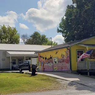 a yellow house with an american flag painted on it