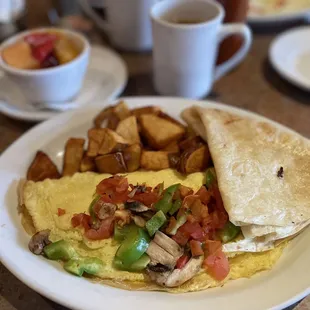an omelet with a side of potatoes