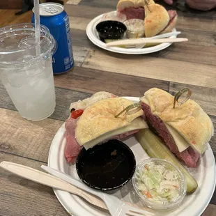 a half eaten sandwich with pickles and pickles