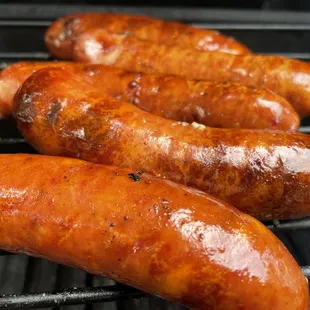 three sausages on a grill