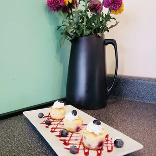 a plate of blueberry cheesecakes