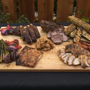 a variety of meats on a cutting board