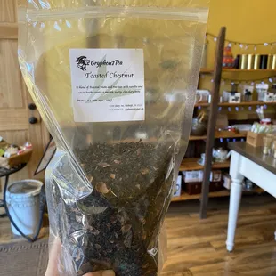 a hand holding a bag of tea