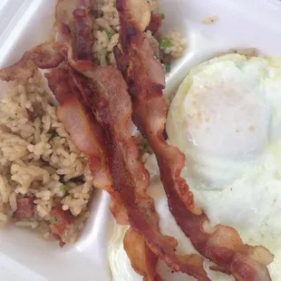 Fried rice with over easy eggs and bacon