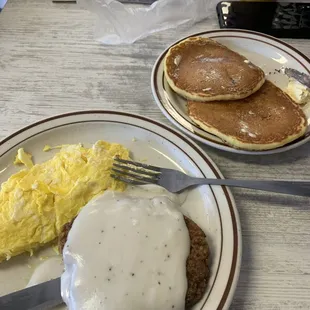 Country fried steak, scrambled eggs and side of pancakes