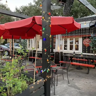 a patio with tables and umbrellas