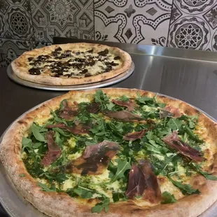 1. Mozzarella, Marinara, Basil, Prosciutto, Arugula
2. Funghi: Wild Mushrooms, Roasted Garlic, Goat Cheese ;)