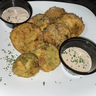 a plate of fried vegetables and dips
