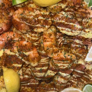 a platter of shrimp and lemons