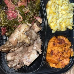 a meal of meat, vegetables and macaroni and cheese
