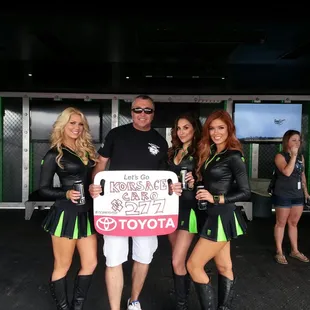 a man holding a sign with a group of girls