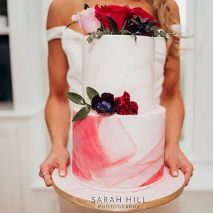 a woman holding a cake