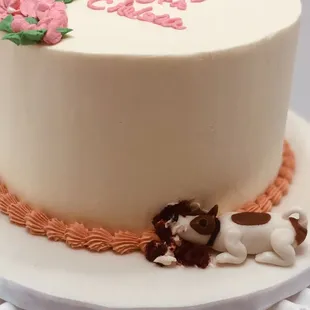 a white cake with pink and green icing