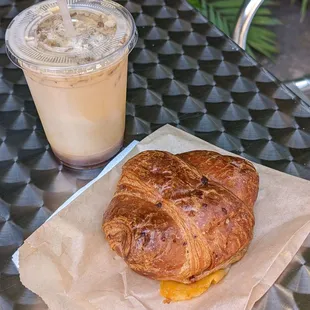 A Lavender Honey Oat Milk Latte and Ham and Cheese Croissant