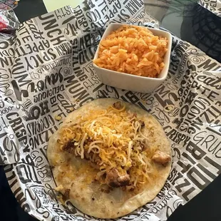 Chicken and cheese flour taco with rice.