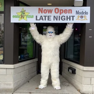 man dressed as a polar bear holding a sign