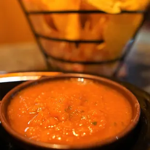 a bowl of chips and a bowl of salsa