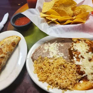 Beef quesidilla, enchilada, beans and rice plate