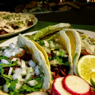 Handmade corn tortilla to be loaded with nopales, onions, cilantro green or red salsa and your choice of one meat:  Carne asada, pork, beef