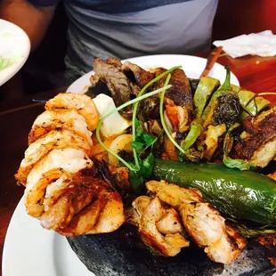 Molcajete de camaron, pollo y carne Asada.  Sizzling!