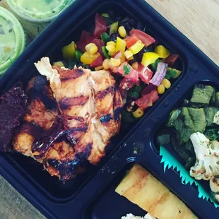 A standard chicken guacbox with yucca mash, nopales, chimichurri cauliflower, grilled pineapple and guacbox caviar.