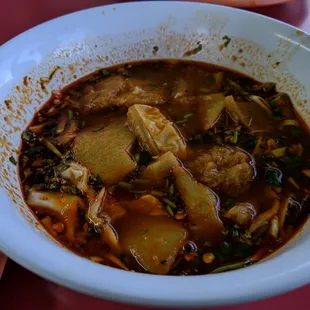 a bowl of soup with meat and vegetables