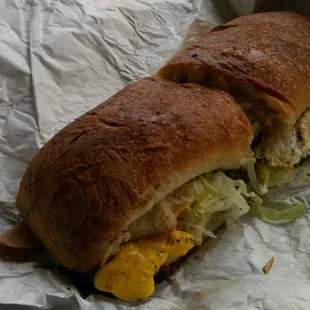 a sandwich wrapped in aluminum foil
