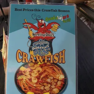 a hand holding a box of crawfish