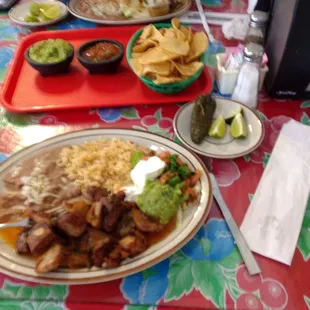 Carnitas plate and side of chips and guacamole.