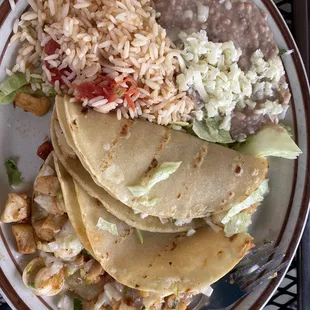 Fish tacos comes with beans, rice, sour cream and yummy green salsa!