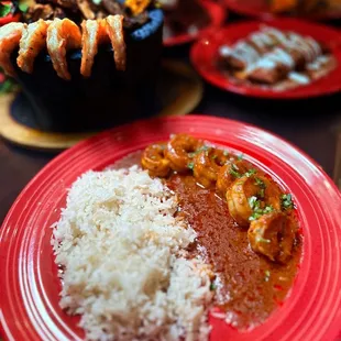 a plate of food with rice and meat