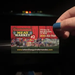 a hand holding a business card