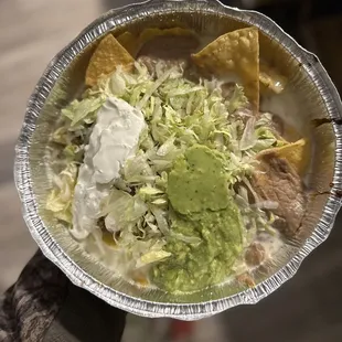 a hand holding a plate of food