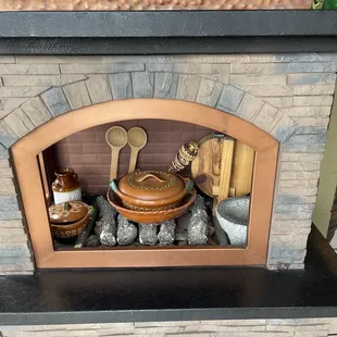 a brick oven with cooking utensils