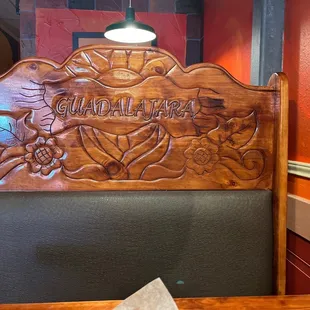 a wooden headboard on a booth
