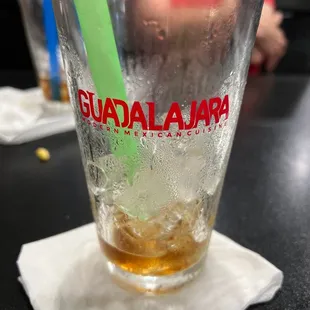 a drink in a glass with a green straw