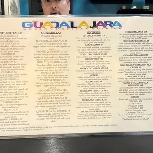a man holding up a menu