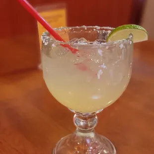 a margarita in a glass with a red straw
