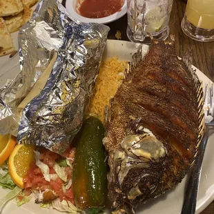 a plate of food with meat, rice, and vegetables