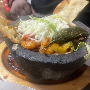 a bowl of mexican food on a table
