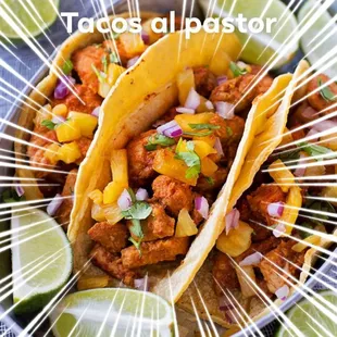 a plate of tacos and lime slices